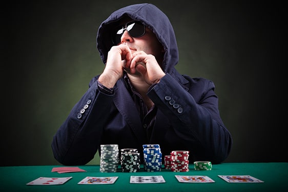 man in sunglasses and a hoodie playing poker