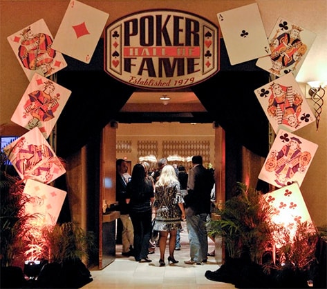 doorway to the Poker Hall of Fame with sign above and giant playing cards surrounding the entrance