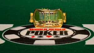 World Series of Poker bracelet atop a WSOP logo