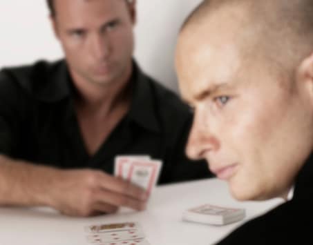 over-the-shoulder view of a heads-up poker game. Sly looks