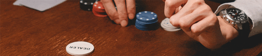 player in dealer position moving chips forward towards