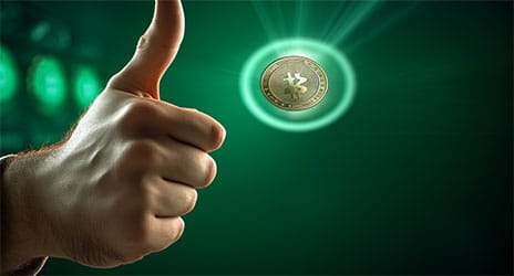 hand flipping a bitcoin coin into the air