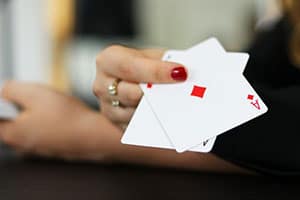 woman's hand folding two aces